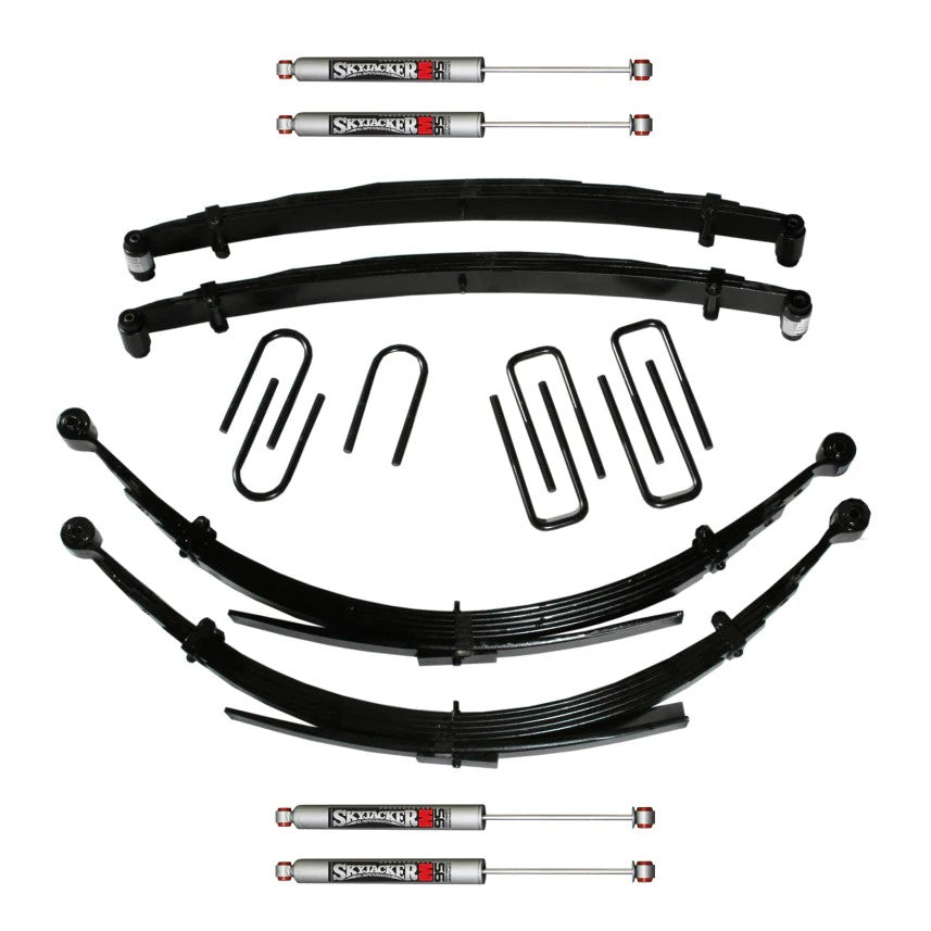 Skyjacker 6-inch suspension lift system with leaf springs, U-bolts, and four silver M95 Monotube shocks.