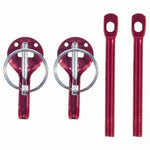 Red anodized aluminum Sparco hood pin kit including pins, scuff plates, and mounting hardware.