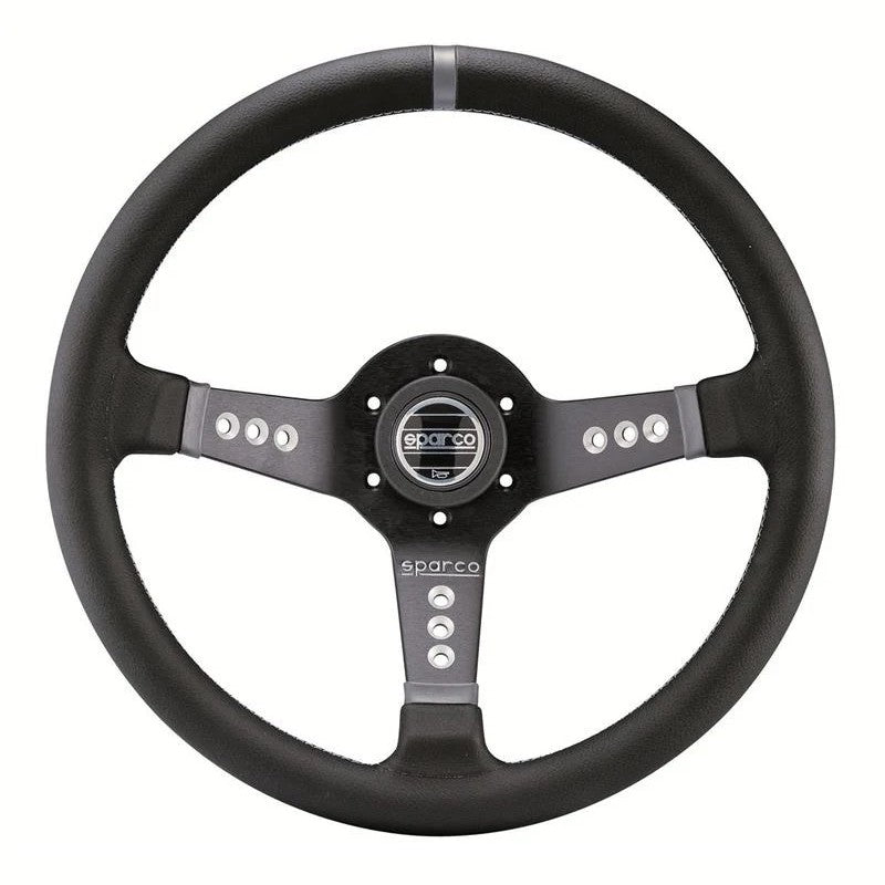 Sparco L777 black leather three-spoke steering wheel with centered horn button and aluminum frame.