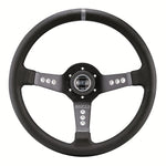 Sparco L777 black leather three-spoke steering wheel with centered horn button and aluminum frame.