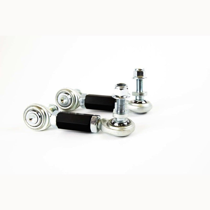 Pair of black anodized SPL PRO rear swaybar endlinks with Teflon-lined FK rod ends and high misalignment studs.