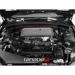 Tanabe Sustec front strut tower bar with silver aluminum crossbar and red steel mounting brackets.