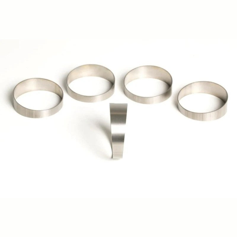 Five Ticon Industries 2.5-inch titanium pie cut segments for 45-degree 3.75-inch CLR loose radius fabrication.