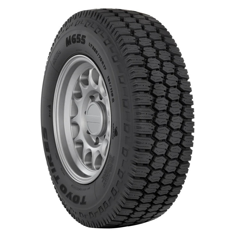 Toyo M655 mixed-service commercial tire showing heavy-duty tread blocks and 285/70R19.5 sidewall markings.