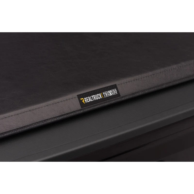 TruXedo TruXport black leather-grain roll-up tonneau cover with 1.5-inch profile on a Chevy Silverado truck bed.