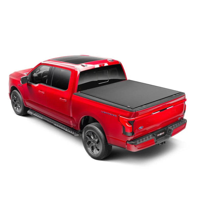 TruXedo Lo Pro black leather-grain vinyl roll-up tonneau cover installed on a 2015-2025 Ford F-150 pickup truck bed.