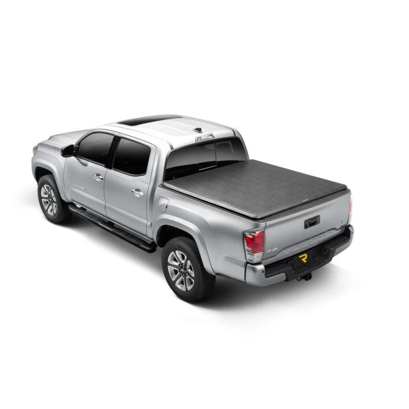 Black TruXedo TruXport soft roll-up bed cover with leather grain finish installed on a Toyota Tacoma 6ft bed.