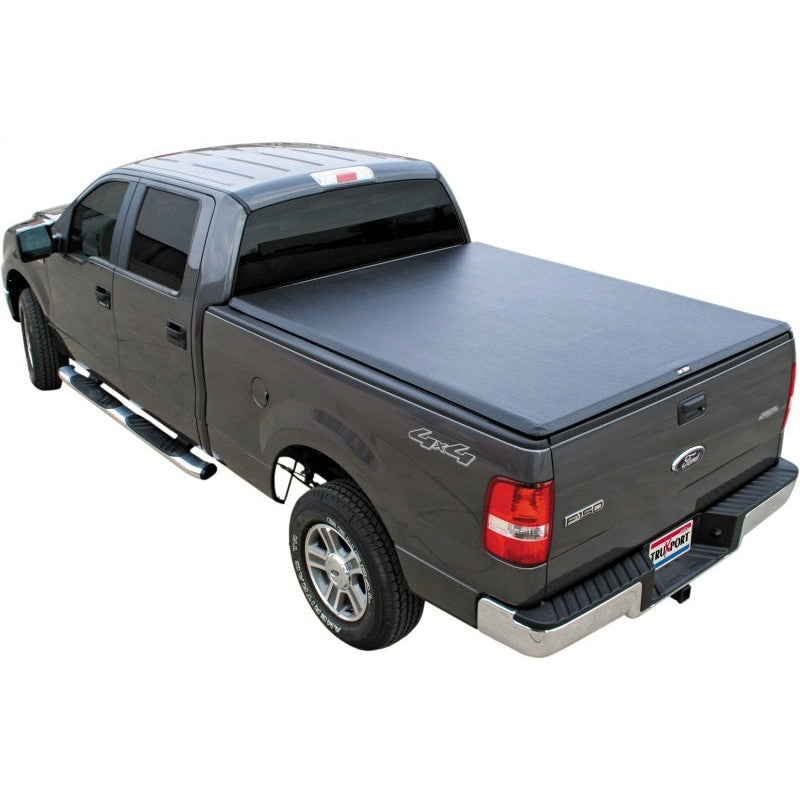 TruXedo TruXport soft roll-up tonneau cover installed on a 1999-2007 Ford Super Duty truck with an 8-foot bed.