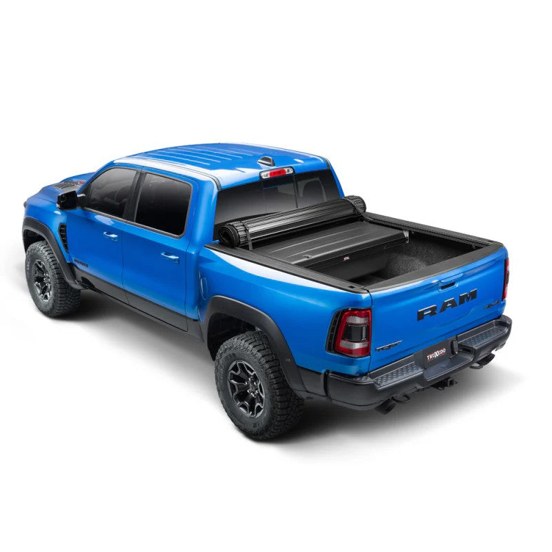 TruXedo TonneauMate black under-the-rail storage toolbox mounted in a full-size truck bed