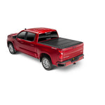 Matte black UnderCover Ultra Flex hard folding tonneau cover with a low profile design on a pickup truck bed