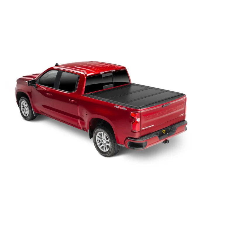 Matte black UnderCover Ultra Flex hard folding tonneau cover with a low profile design on a pickup truck bed