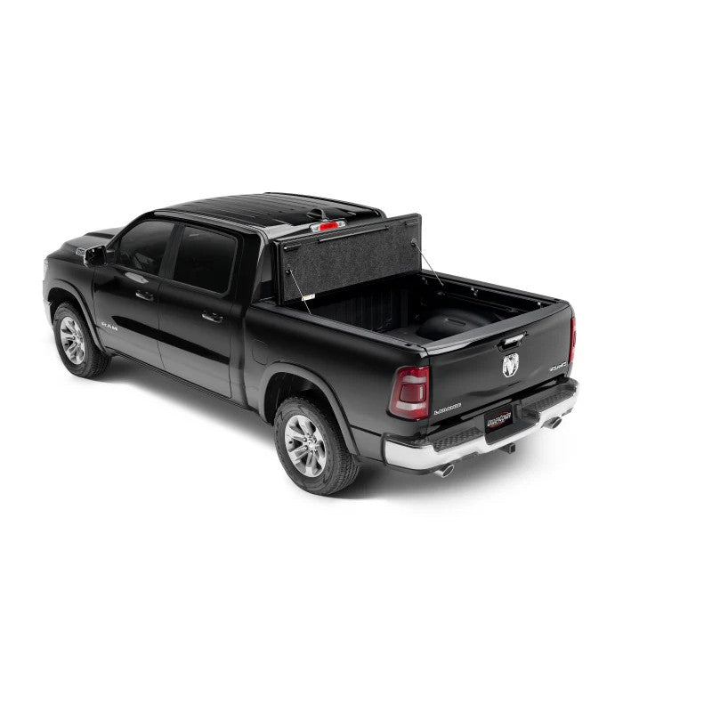 Matte black UnderCover Ultra Flex hard-folding tonneau cover installed on a Ram 1500 truck bed