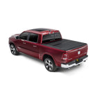 Black textured UnderCover ArmorFlex hard folding tonneau cover with LINE-X coating on a Ram 1500 5.7ft truck bed.