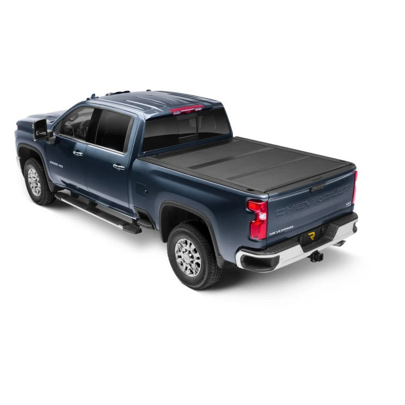UnderCover ArmorFlex hard folding tonneau cover with matte black LINE-X coating installed on a truck bed
