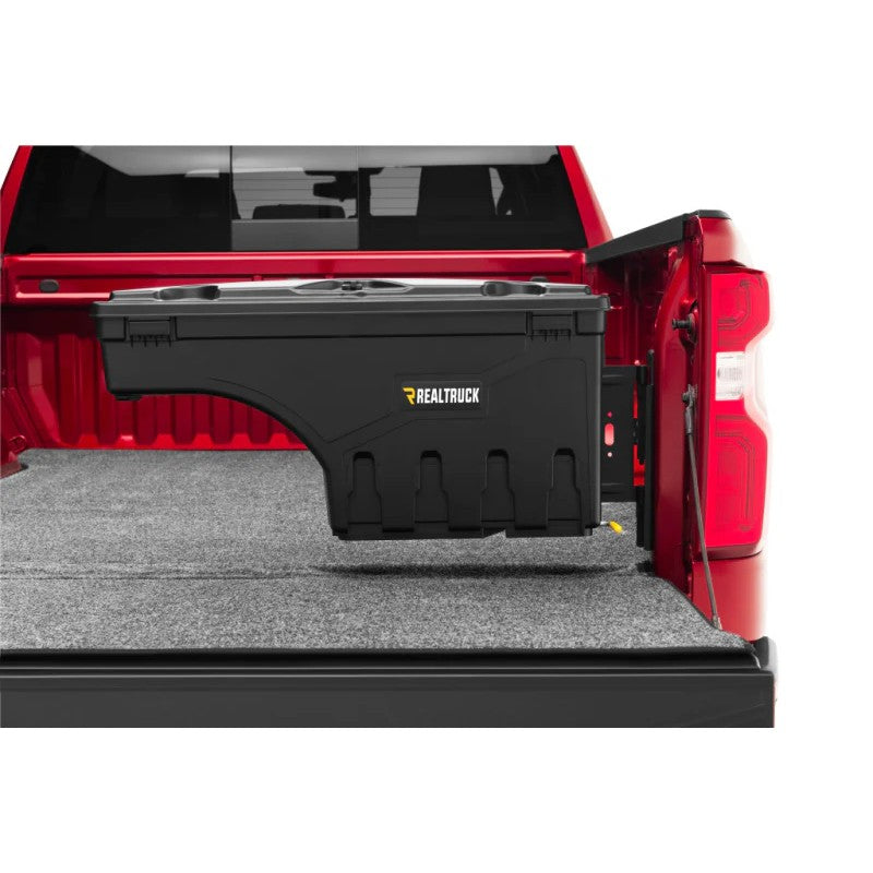 Black smooth UnderCover SwingCase passenger side truck bed storage box installed on a 2022-2026 Nissan Frontier.