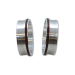 A pair of machined 6061 aluminum weld ferrules for 3.5 inch OD tubing with black rubber O-ring seals.