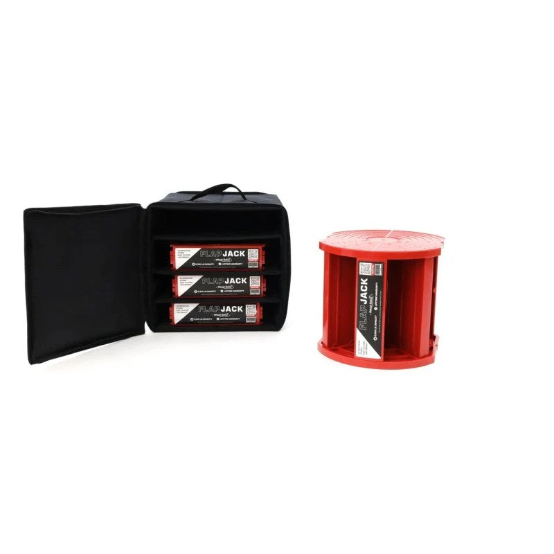 Four black interlocking Weigh Safe Flap Jack leveling blocks stacked beside a zippered storage bag.