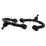 Whiteline KTA249 front upper control arms featuring black powder coating and maintenance-free GIIRO bushings.