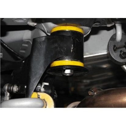 Whiteline KDT921 rear crossmember-mount elastomer bushing inserts with molybdenum grease and installation hardware.
