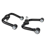 Pair of Whiteline black fixed offset front upper control arms with maintenance-free GIIRO bushings for Nissan Frontier.