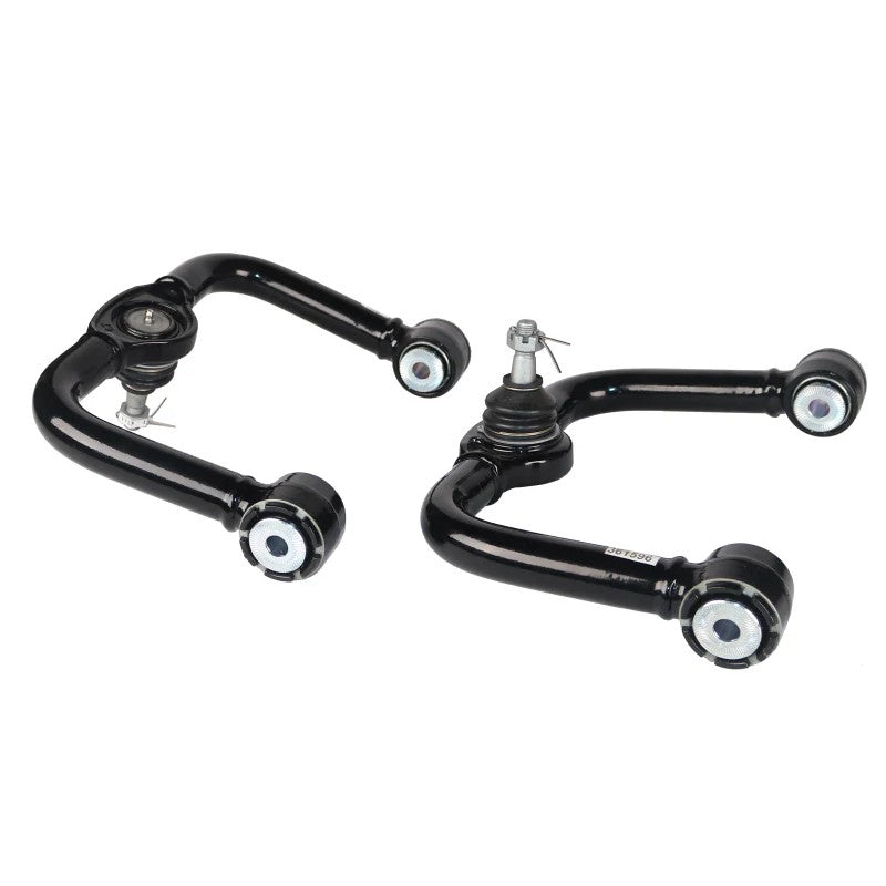 Pair of Whiteline black fixed offset front upper control arms with maintenance-free GIIRO bushings for Nissan Frontier.