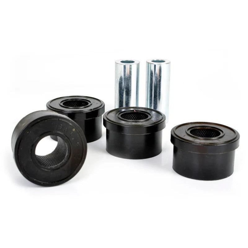 Whiteline Plus W63401 synthetic elastomer rear lower inner control arm bushings with metal sleeves and mounting grease.
