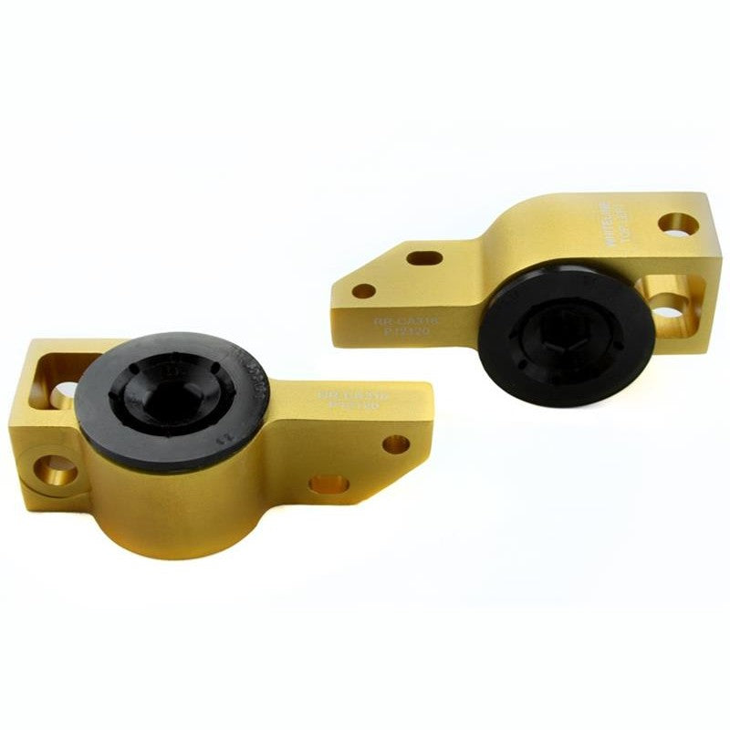 Whiteline KCA316 front lower control arm anti-lift caster kit featuring gold anodized alloy mounts and black bushings.