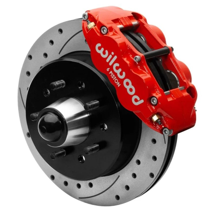 Wilwood Forged Narrow Superlite 6R front big brake kit featuring red 6-piston calipers and 12.19-inch drilled rotors.