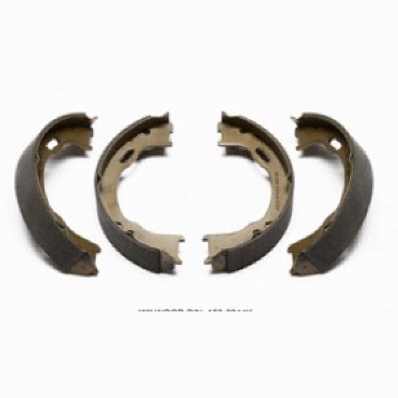 Set of four curved Wilwood parking brake shoes with dark high-friction lining material.