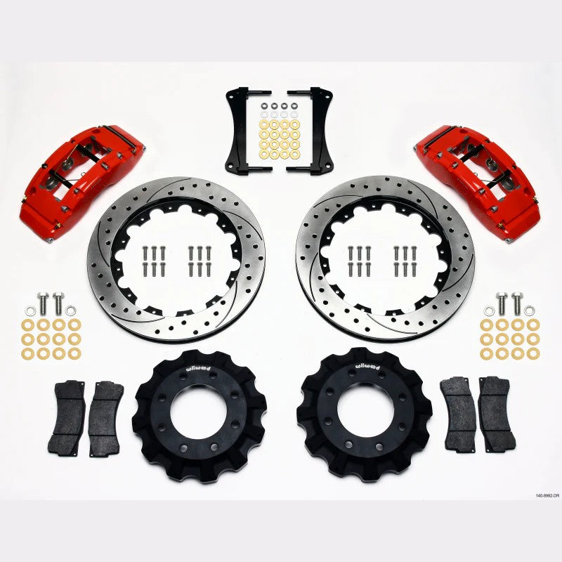 Wilwood TC6R front big brake kit featuring red 6-piston calipers and 16-inch drilled and slotted directional vane rotors.